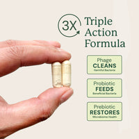 Hand holding two capsules of Animal Biome Gut Maintain with 'Triple Action Formula' text and benefits on a light background