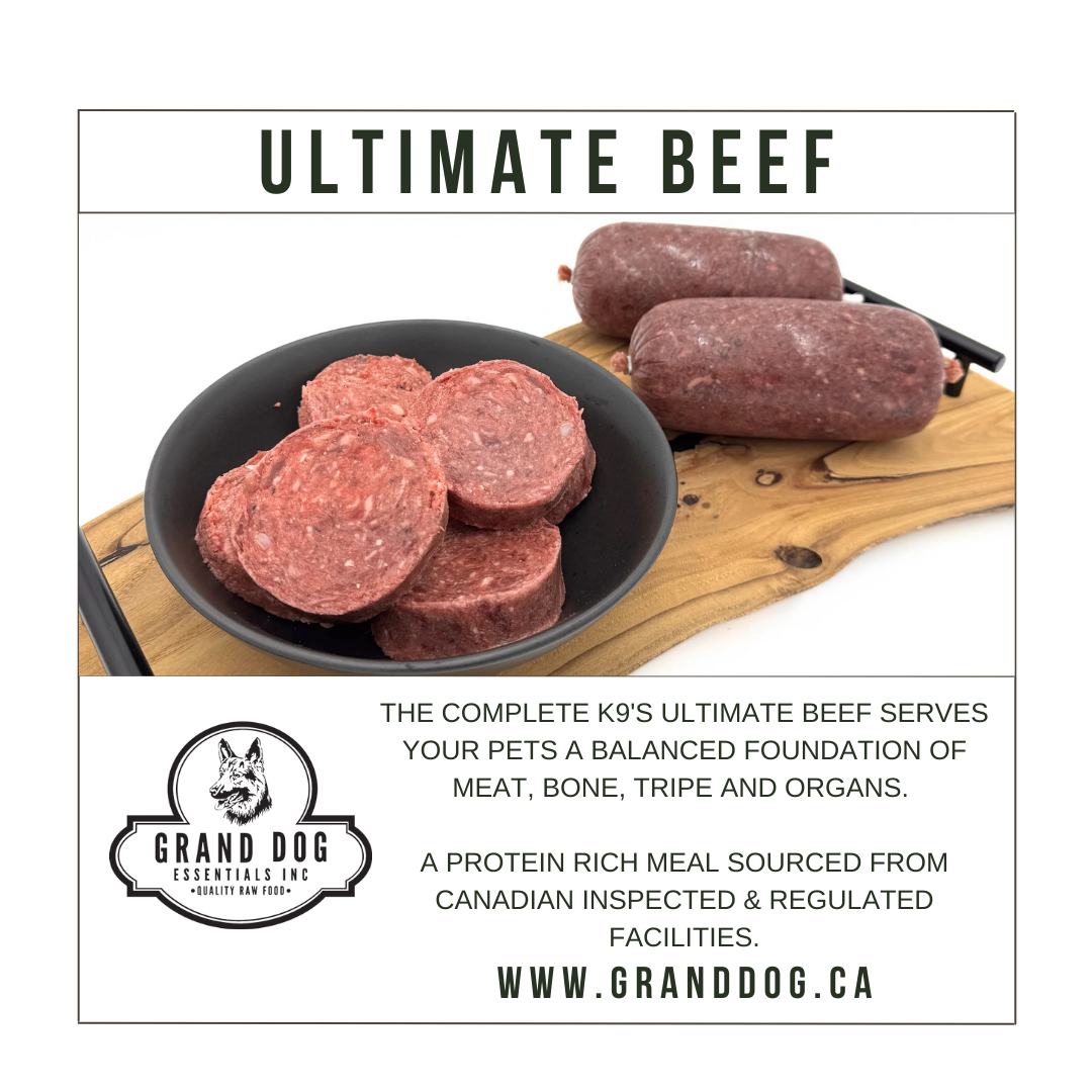 Raw beef products on a cutting board with 'Grand Dog Essentials' branding.