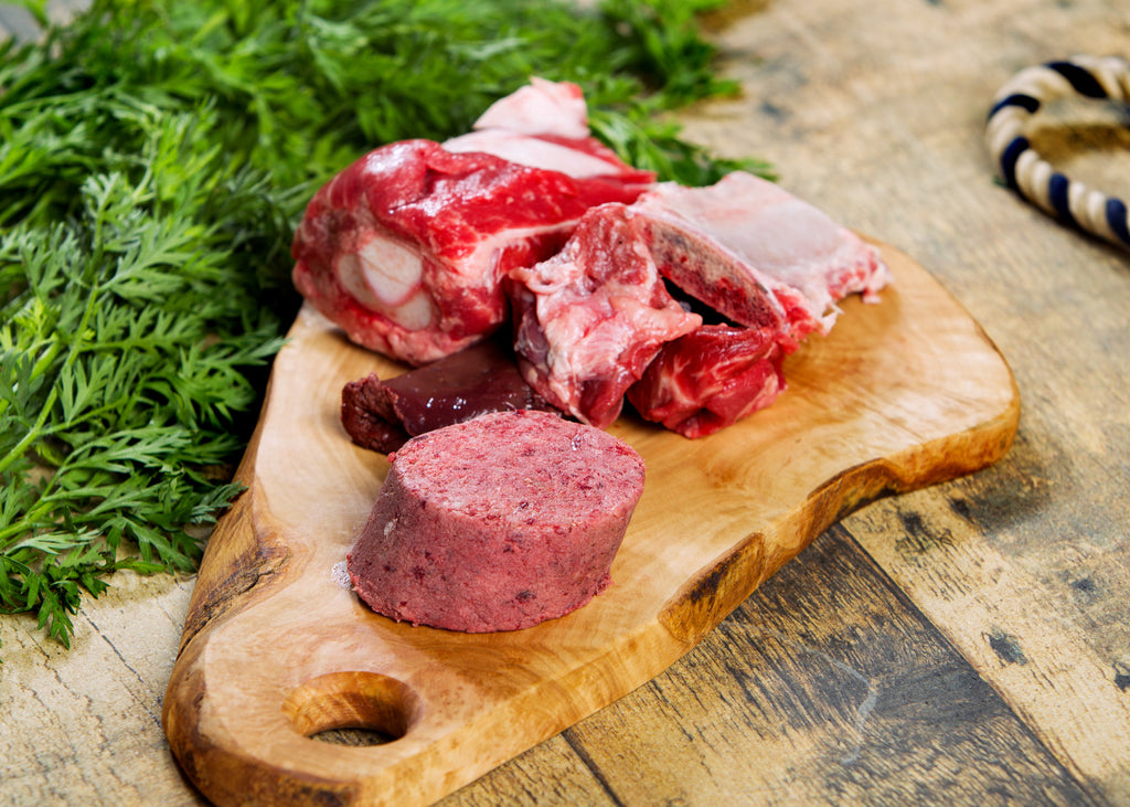 beef raw dog food on a cutting board 