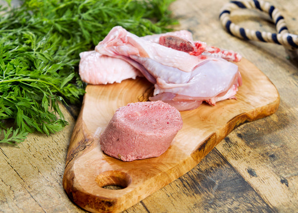 Turkey raw dog food on a cutting board 